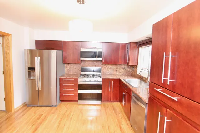 a kitchen with stainless steel appliances a refrigerator and a stove