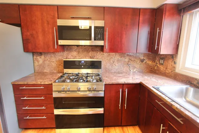 a stove top oven sitting inside of a kitchen