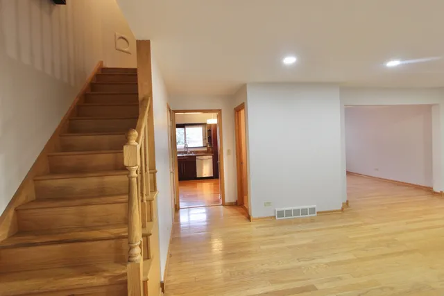 a view of an entryway with wooden floor