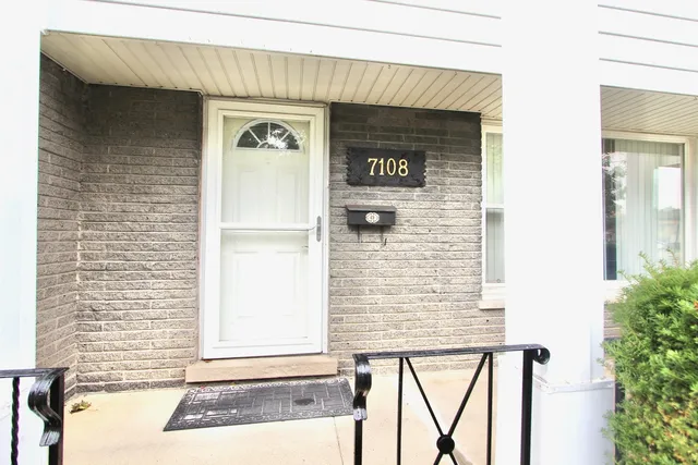a front view of a house with white door