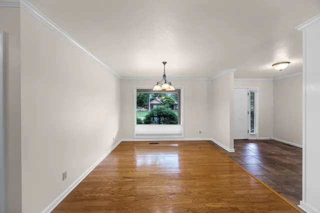 a view of a kitchen with kitchen island a counter top space a sink and appliances