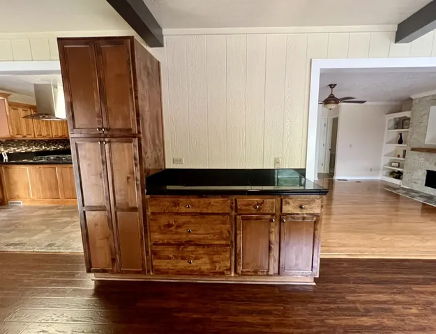 a view of walk in closet with wooden floor