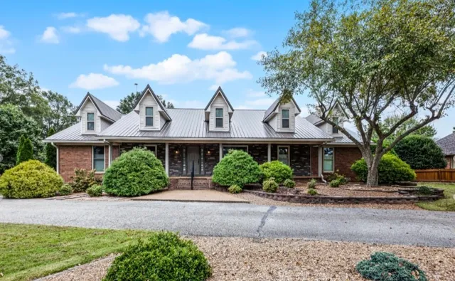 an aerial view of a house with garden space and street view