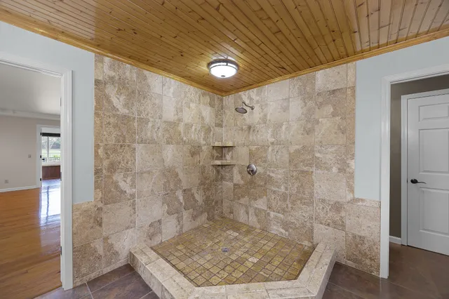 a bathroom with a double vanity sink toilet and a mirror