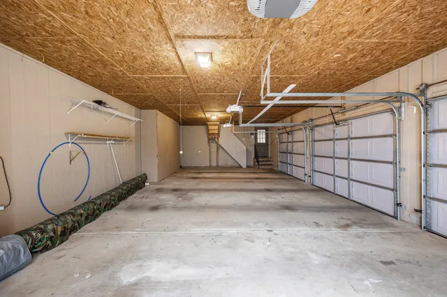 a kitchen with a stove a refrigerator and a view of living room