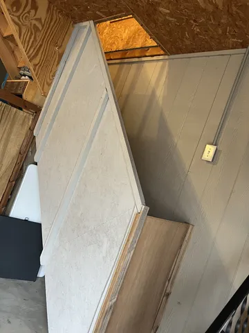 a view of a chairs and table in the balcony