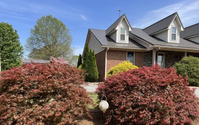 a kitchen island with granite countertop a sink a counter space and cabinets