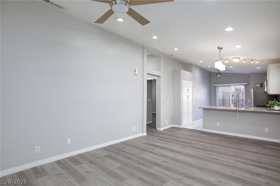 2254 Ramsgate Drive Henderson, NV 89074 - Photo 43 of 43 An open floor plan seamlessly connects the kitchen and living areas, offering contemporary living.