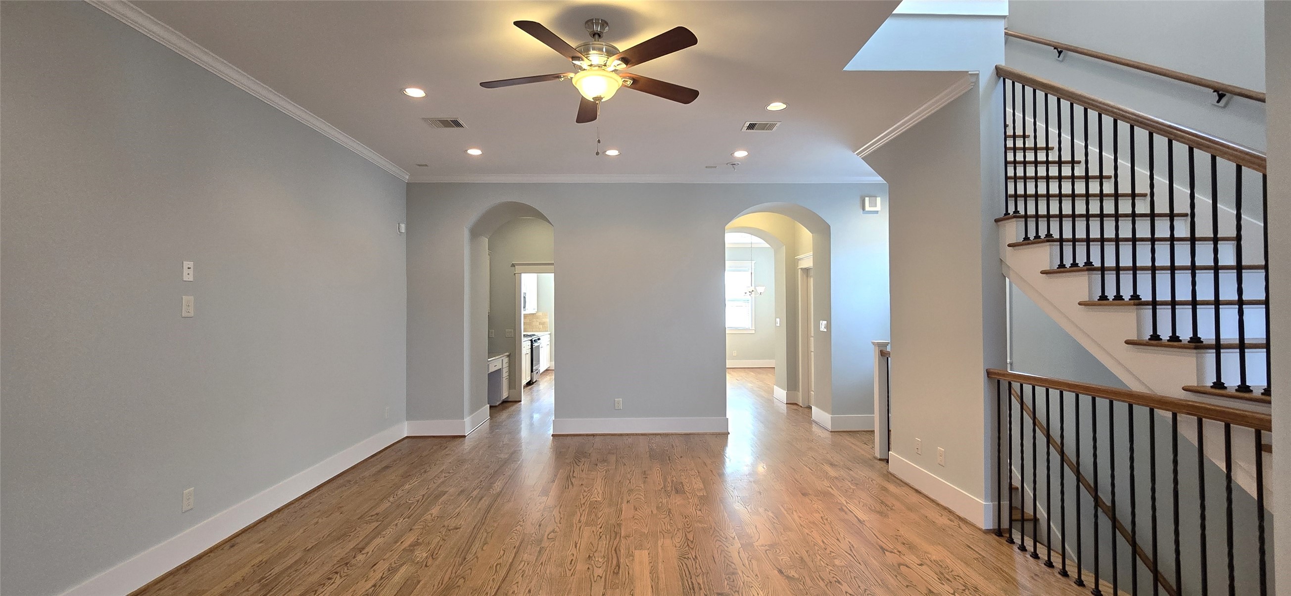 1117 Bonner Street Houston, TX 77007 - Photo 13 of 44 View from the living room with hallways leading to the kitchen and dining area. Stairs on the right lead to the 1st and 3rd floors.