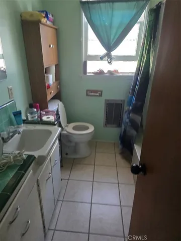 a bathroom with a sink a toilet and a vanity