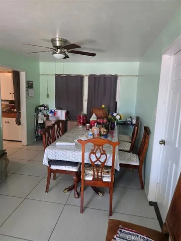 a dining room with furniture and a chandelier