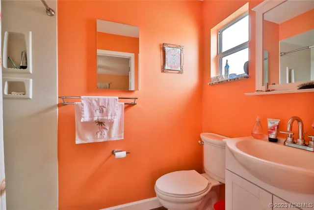 a bathroom with a toilet sink and mirror