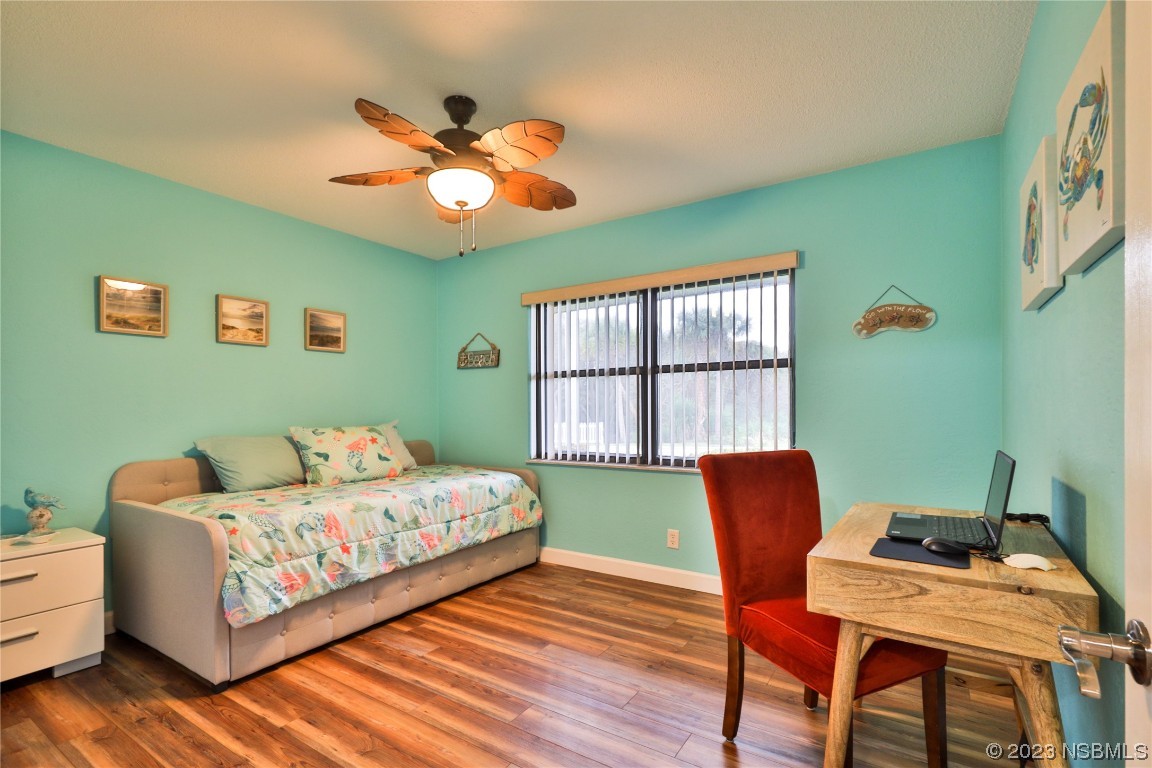 4701 South Peninsula Drive Ponce Inlet, FL 32127 - Photo 18 of 32 a bedroom with a bed and a chair