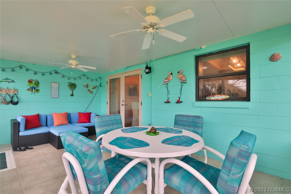 4701 South Peninsula Drive Ponce Inlet, FL 32127 - Photo 25 of 32 a view of a dining room with furniture and a flat screen tv