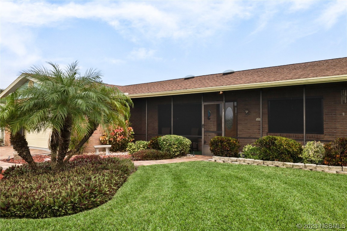 4701 South Peninsula Drive Ponce Inlet, FL 32127 - Photo 3 of 32 a front view of a house with garden
