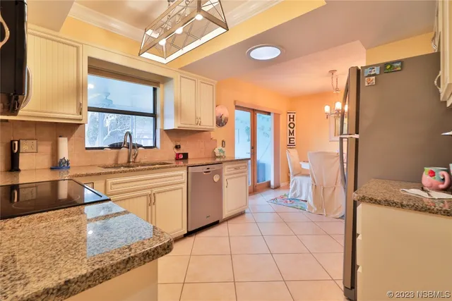 a kitchen with a sink a stove and cabinets