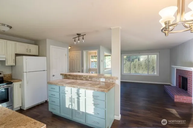 a view of kitchen with furniture and wooden floor