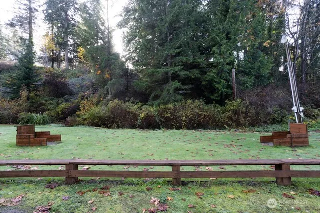 a view of a yard with wooden fence