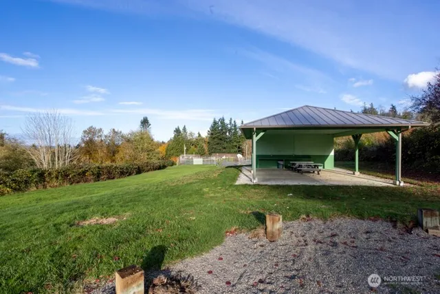 a view of a garden with a bench under an umbrella