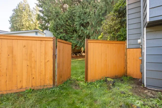 a view of a house with backyard and tree