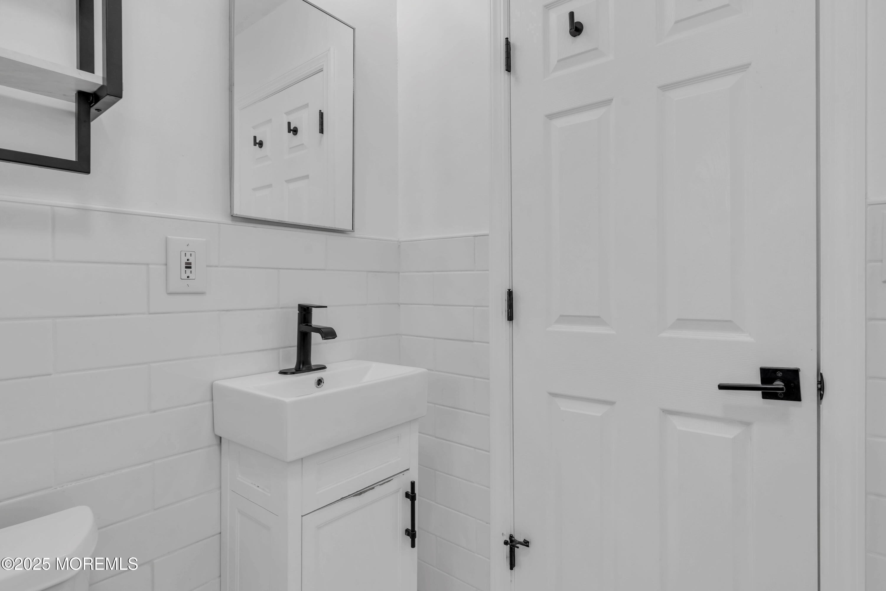 69 Pinehurst Road Brick, NJ 08723 - Photo 23 of 33 a bathroom with a sink and mirror