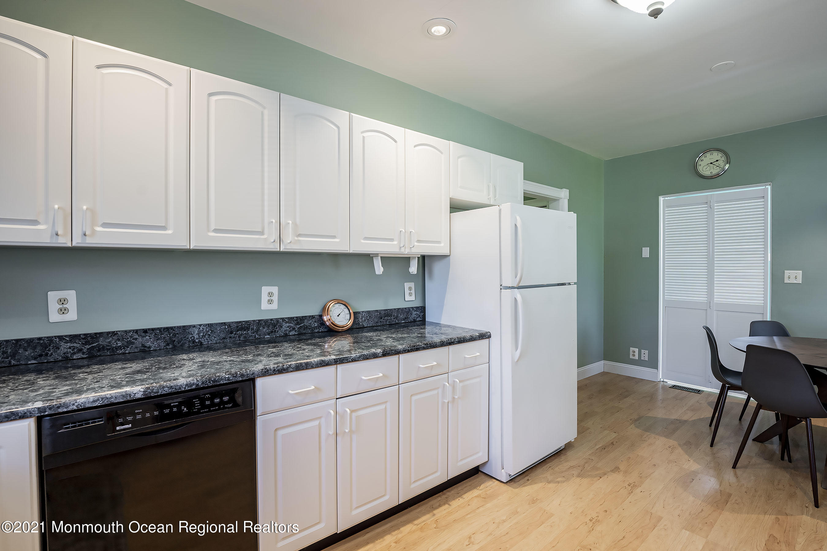 132 Sampson Place Long Branch, NJ 07740 - Photo 12 of 20 a kitchen with granite countertop a refrigerator sink and white cabinets