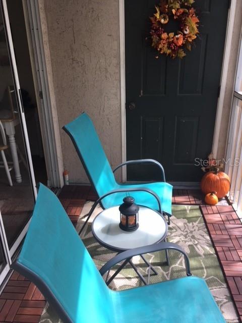 8939 Latrec Avenue, Unit 1205 Orlando, FL 32819 - Photo 11 of 15 a backyard of a house with dining table and chairs