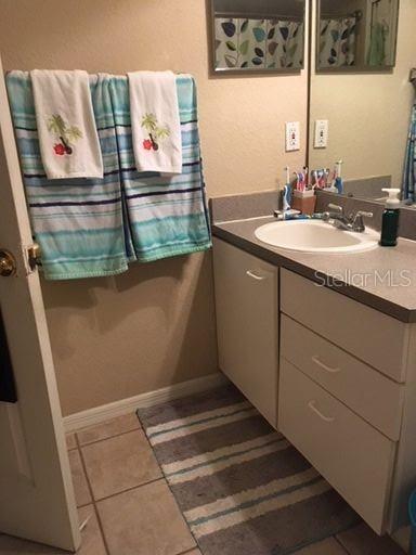 8939 Latrec Avenue, Unit 1205 Orlando, FL 32819 - Photo 14 of 15 a bathroom with a sink and a mirror