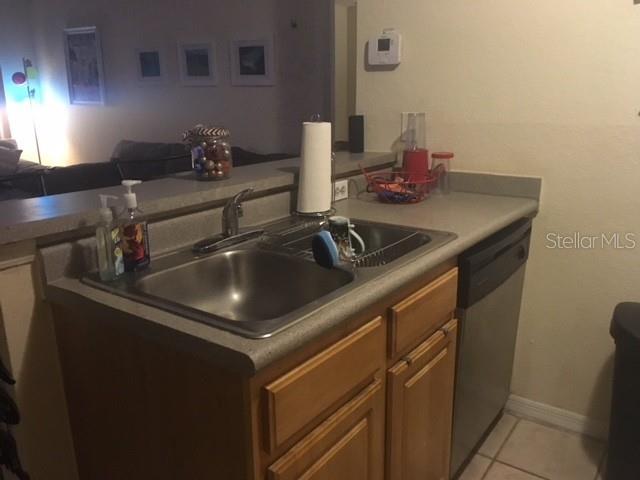 8939 Latrec Avenue, Unit 1205 Orlando, FL 32819 - Photo 9 of 15 a kitchen with a sink and cabinets