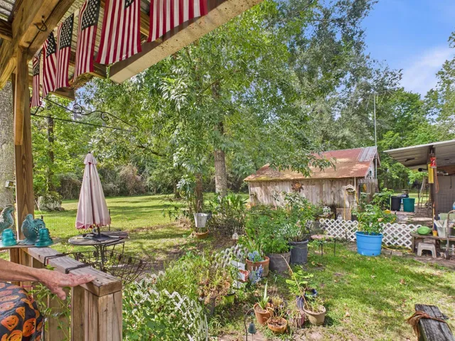 a backyard of a house with table and chairs