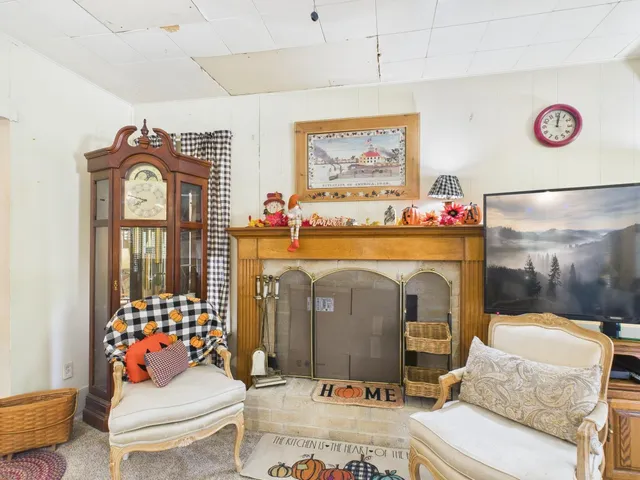 a living room with furniture fireplace and window