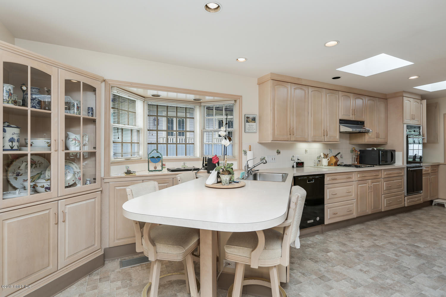 11 Wahneta Road Old Greenwich, CT 06870 - Photo 7 of 26 a kitchen with granite countertop white cabinets and stainless steel appliances