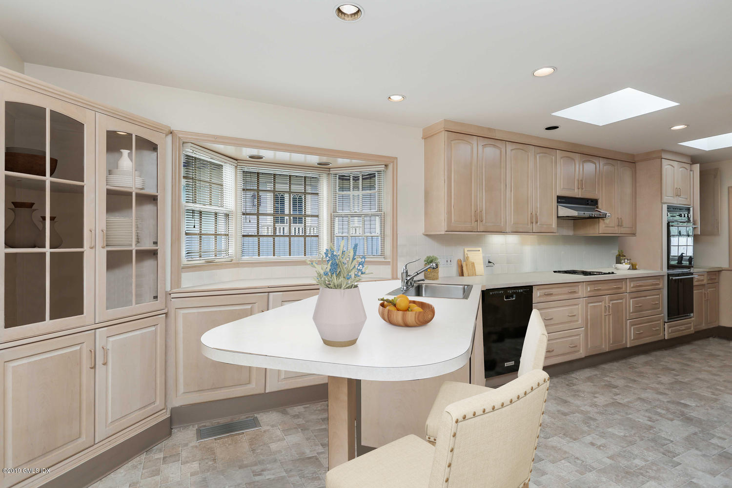 11 Wahneta Road Old Greenwich, CT 06870 - Photo 8 of 26 a kitchen with a sink dining table and chairs