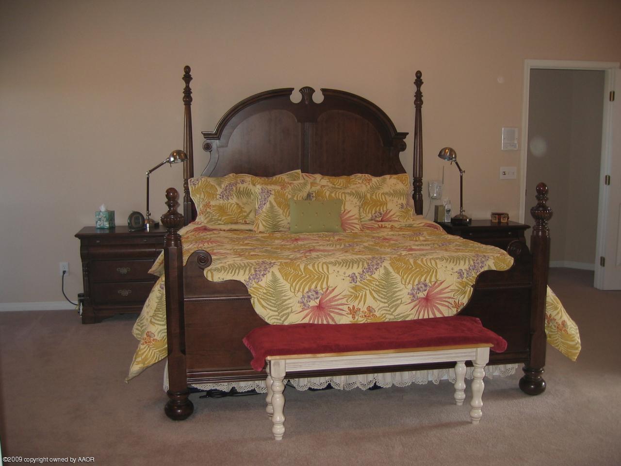 711 McKenzie Road Amarillo, TX 79118 - Photo 7 of 38 a bed sitting in a bedroom next to a window