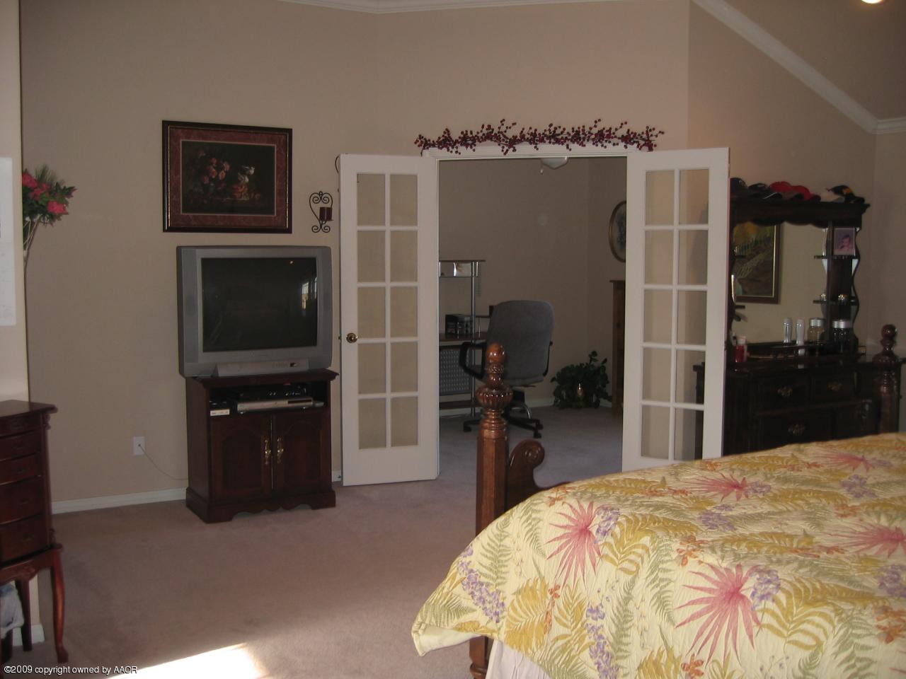 711 McKenzie Road Amarillo, TX 79118 - Photo 9 of 38 a bedroom with a bed and a television