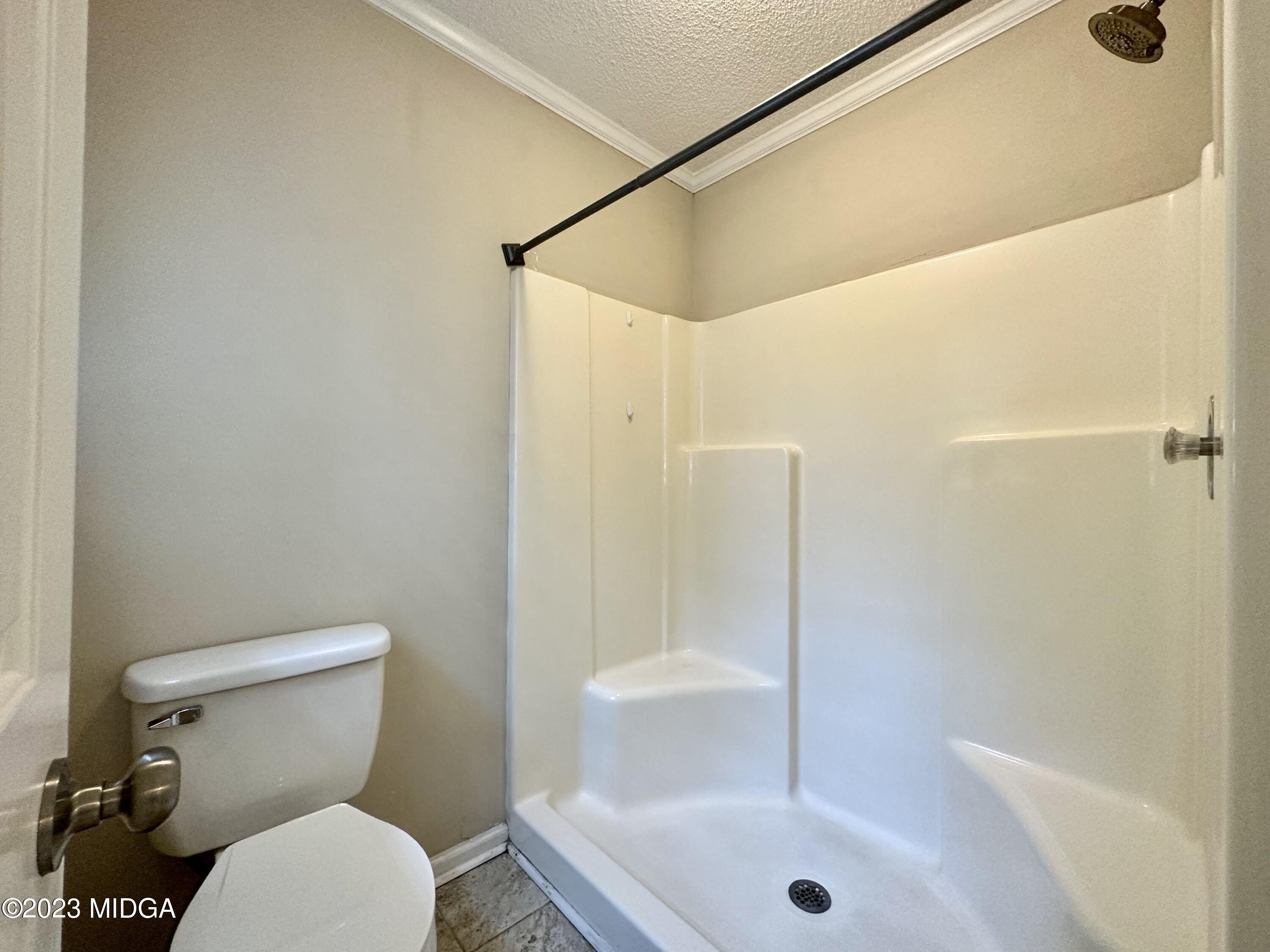 310 Old Oak Road Macon, GA 31216 - Photo 14 of 27 a white toilet sitting next to a bath tub