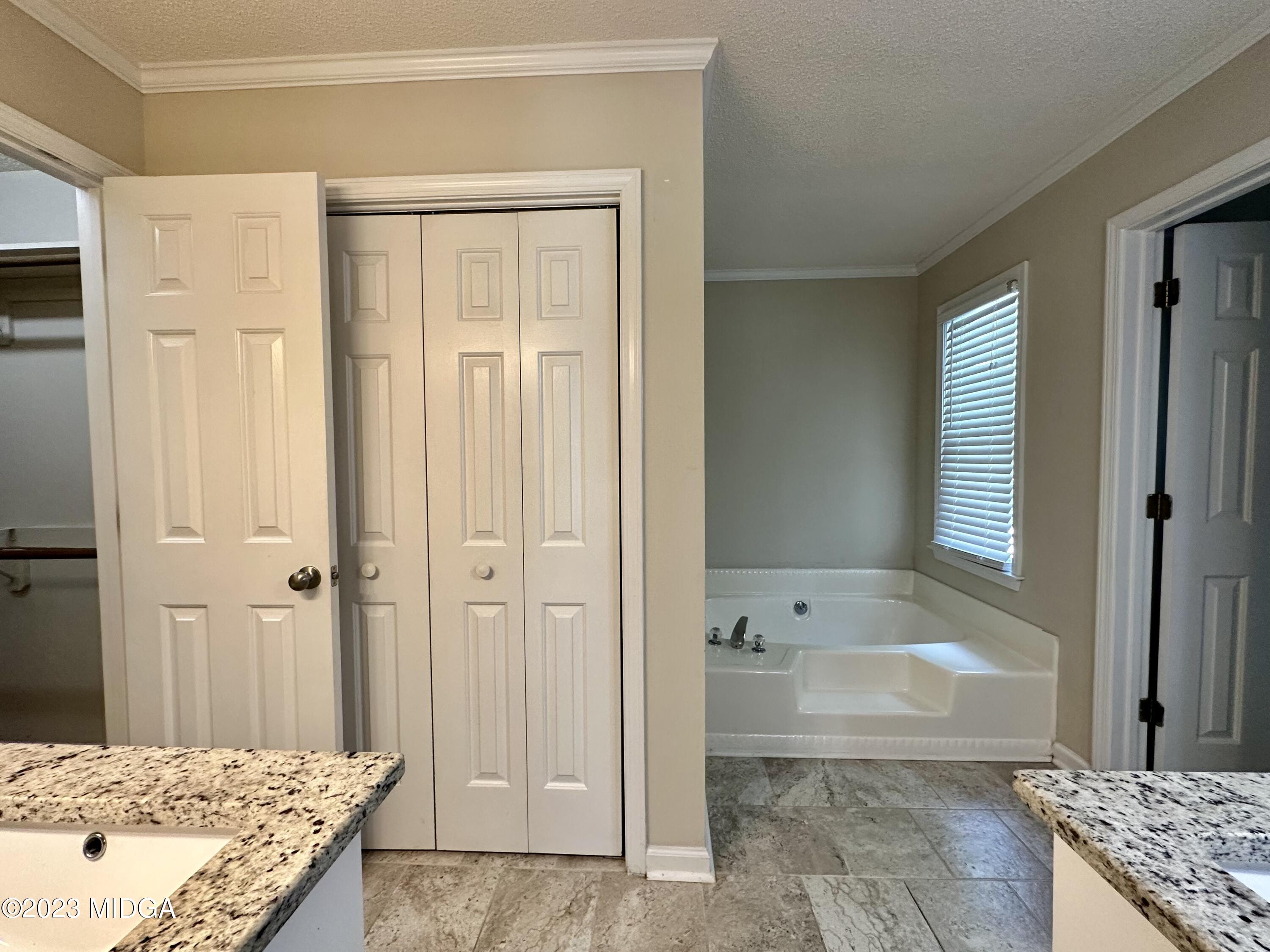 310 Old Oak Road Macon, GA 31216 - Photo 15 of 27 a bathroom with a granite countertop sink a toilet and shower