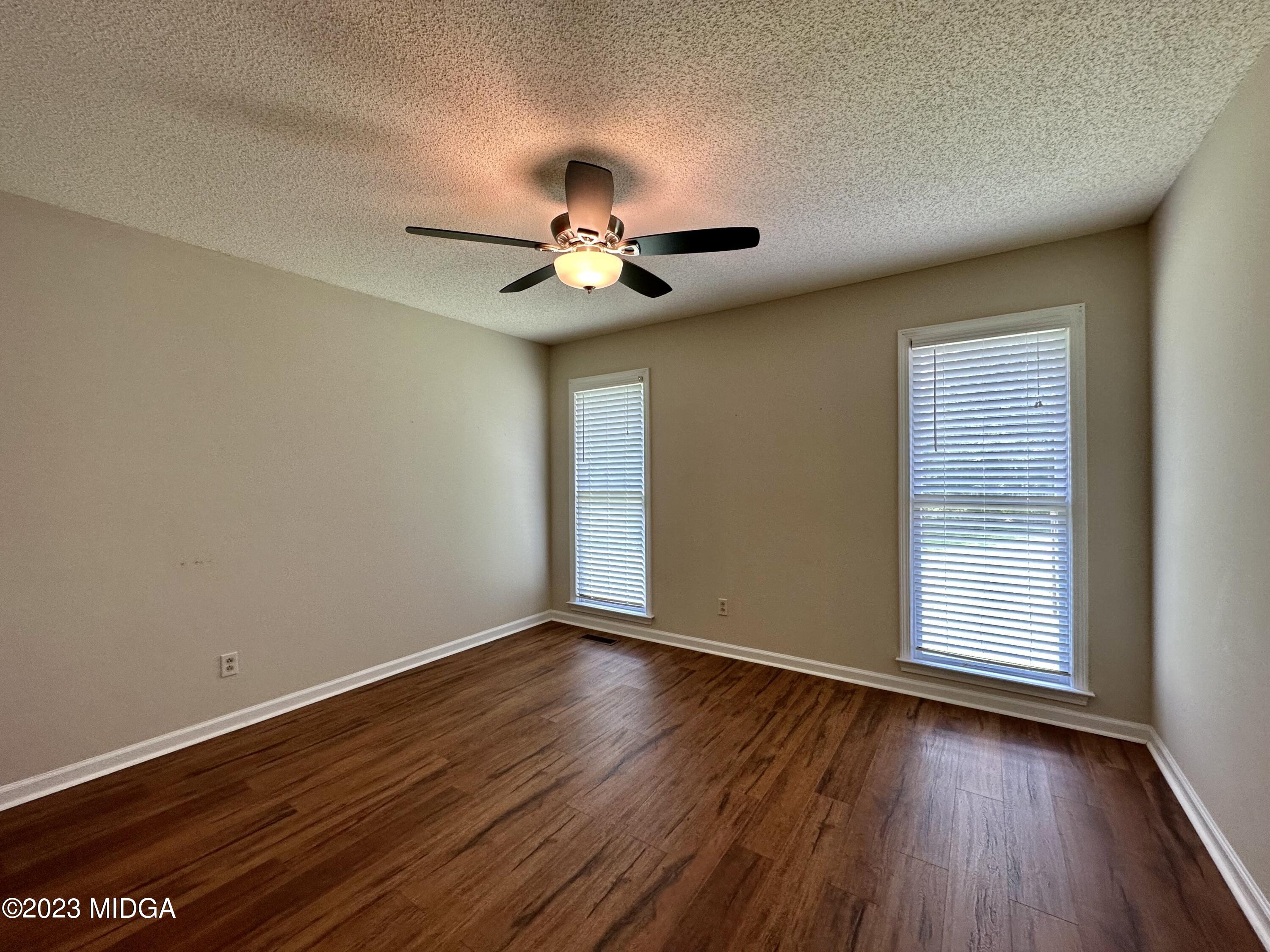 310 Old Oak Road Macon, GA 31216 - Photo 17 of 27 a view of room with a ceiling fan and wooden floor