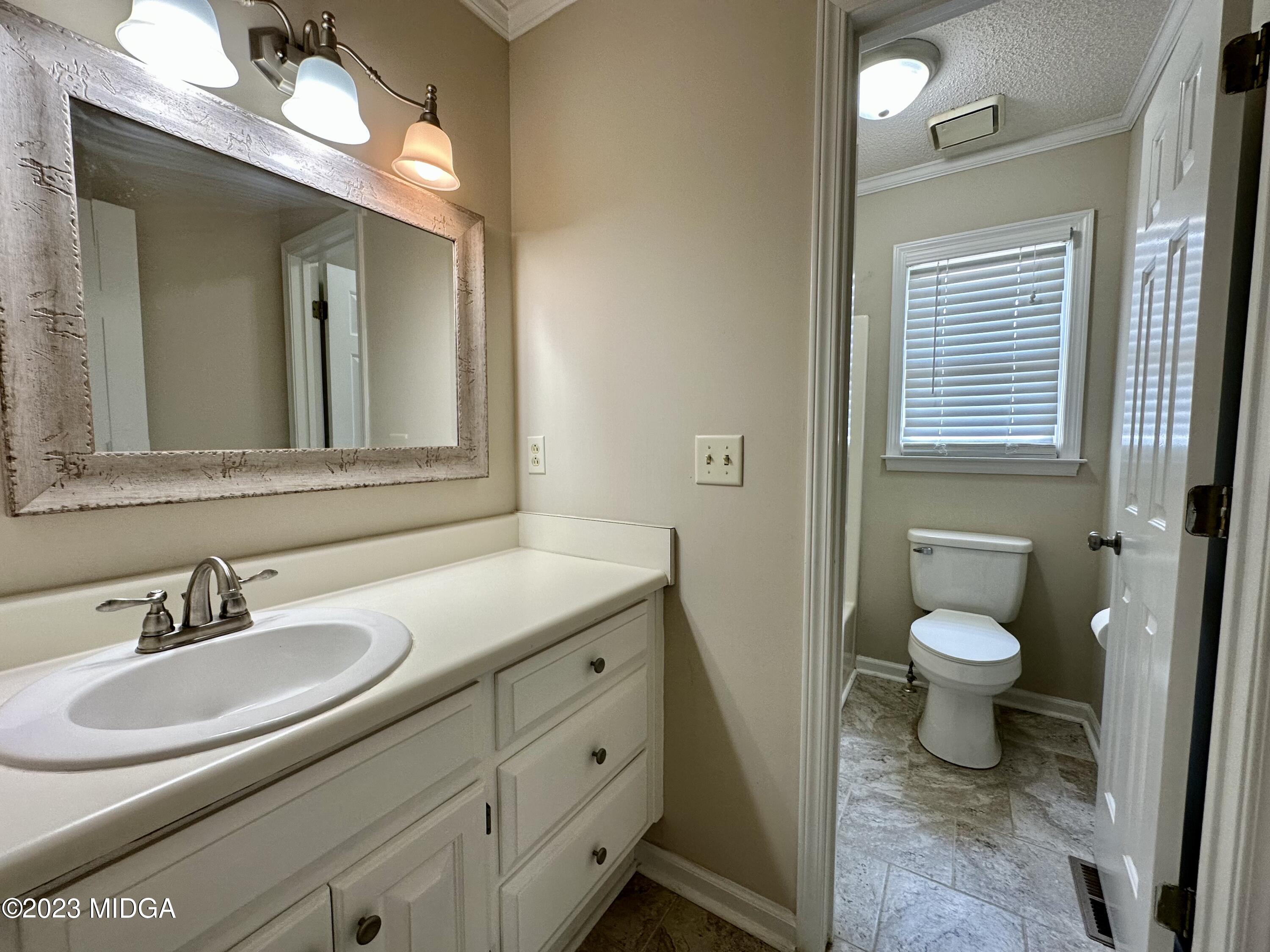 310 Old Oak Road Macon, GA 31216 - Photo 18 of 27 a bathroom with a toilet sink and mirror