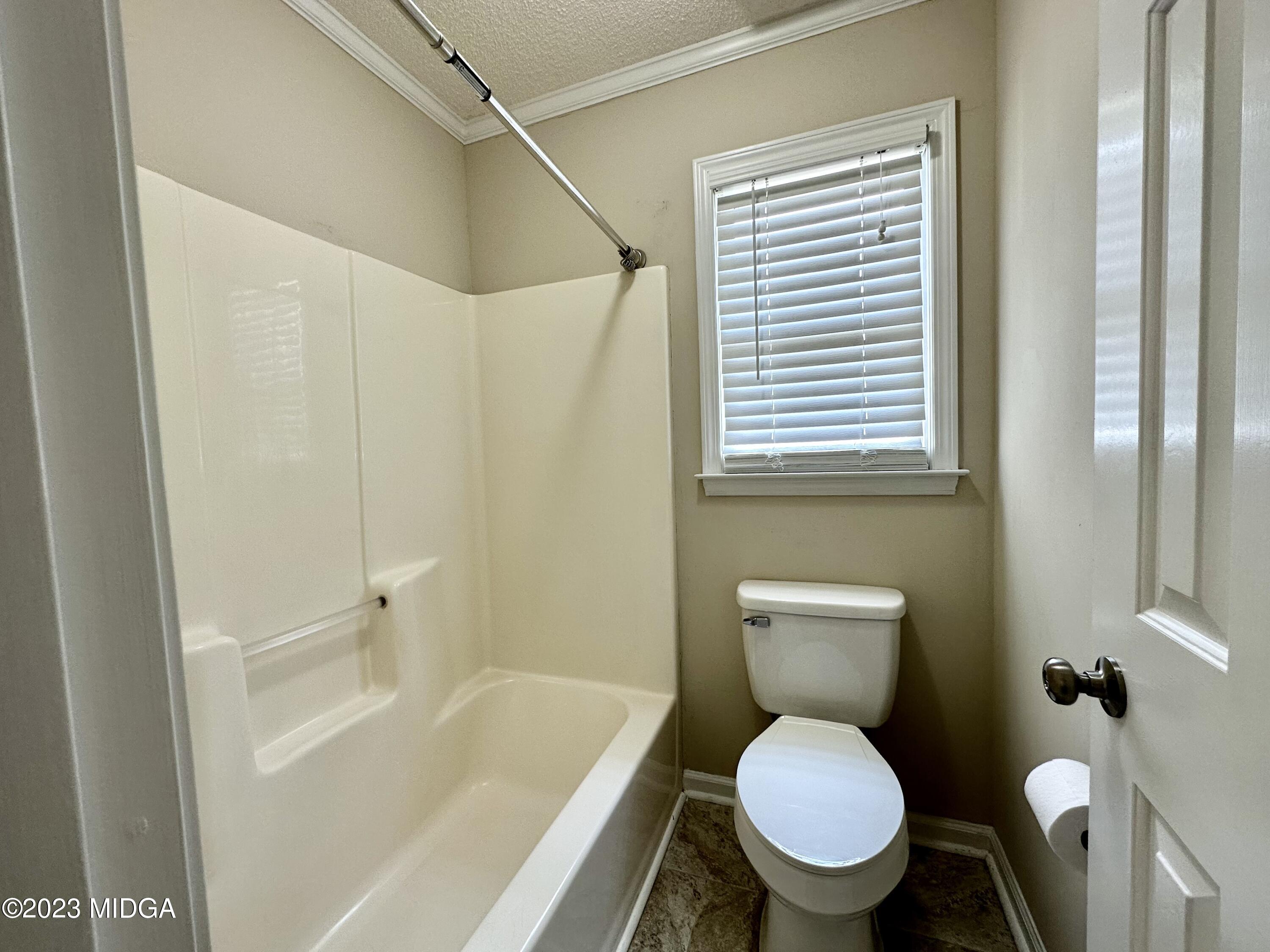 310 Old Oak Road Macon, GA 31216 - Photo 19 of 27 a white toilet sitting next to a bath tub