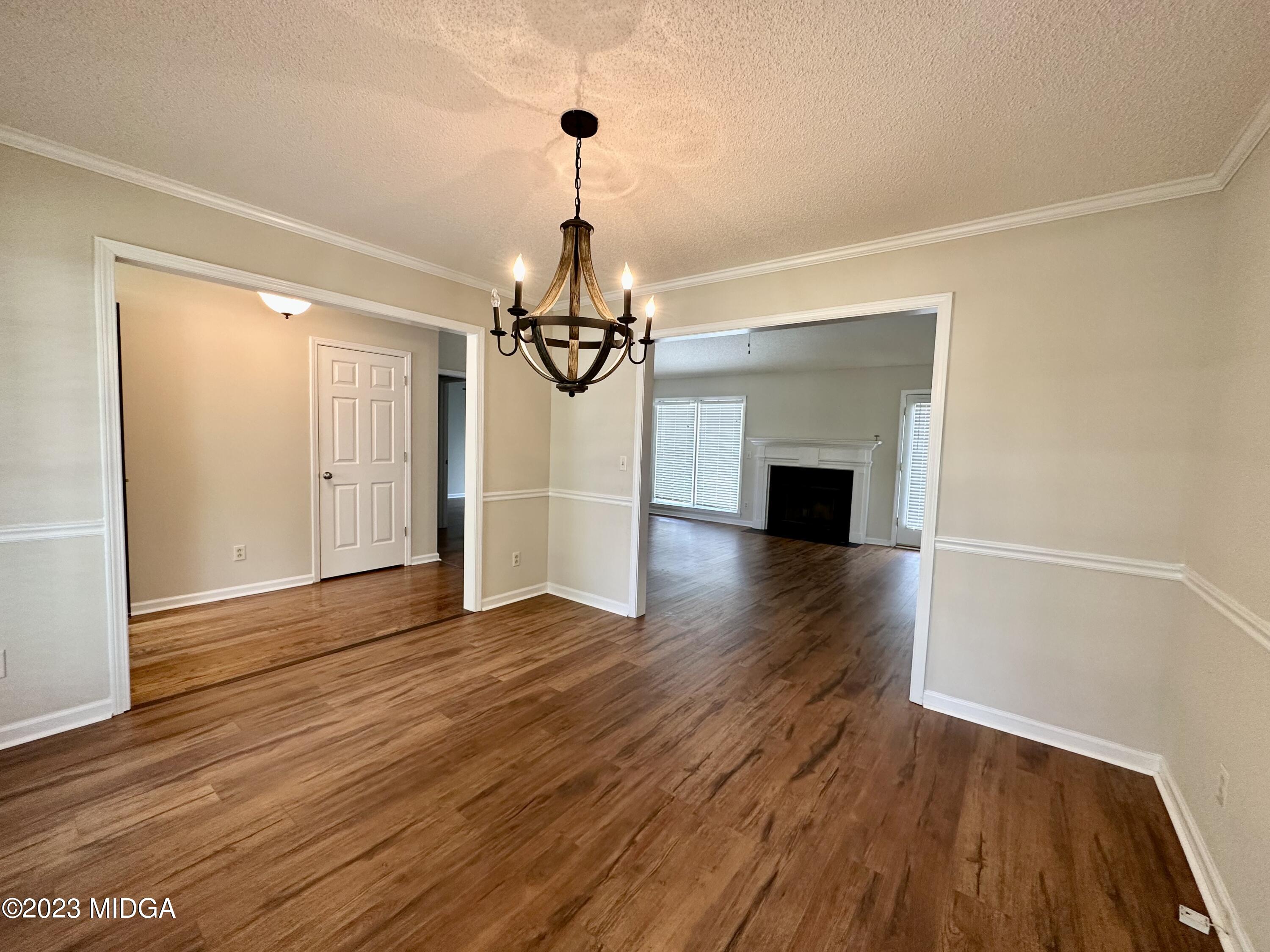 310 Old Oak Road Macon, GA 31216 - Photo 3 of 27 a view of a livingroom with wooden floor staircase and a chandelier
