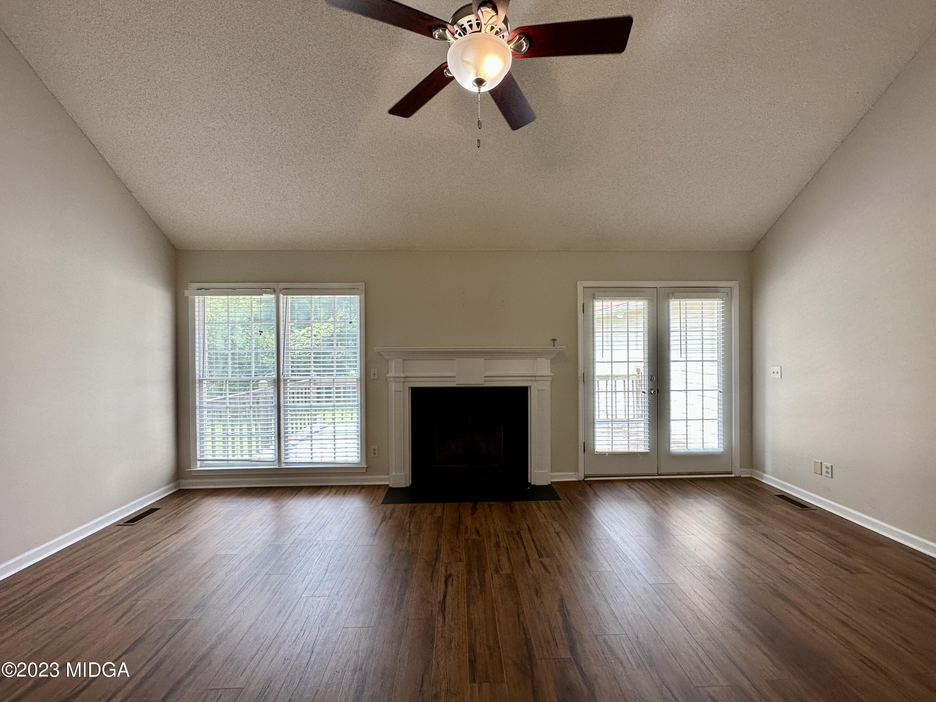 310 Old Oak Road Macon, GA 31216 - Photo 4 of 27 a view of an empty room with wooden floor and a window