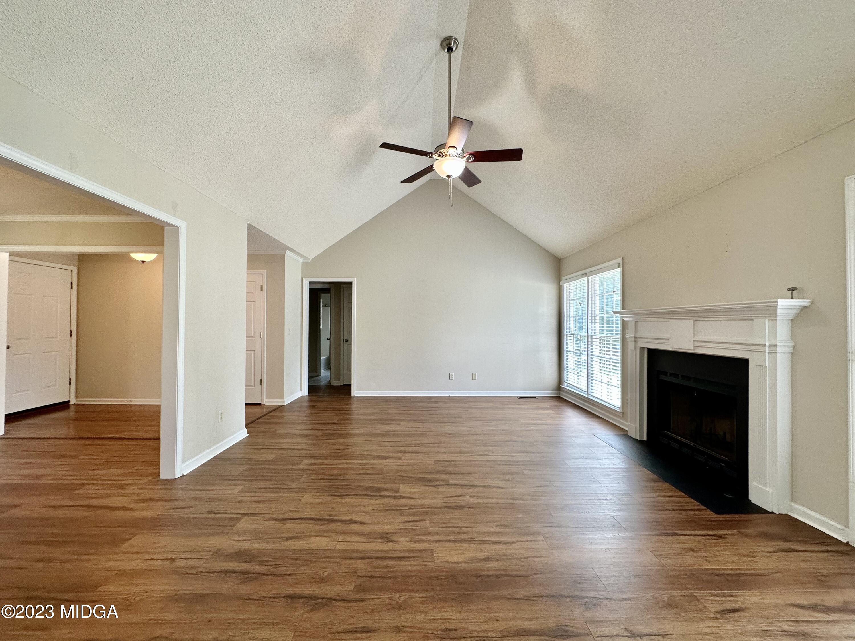 310 Old Oak Road Macon, GA 31216 - Photo 5 of 27 a view of empty room with wooden floor and fireplace