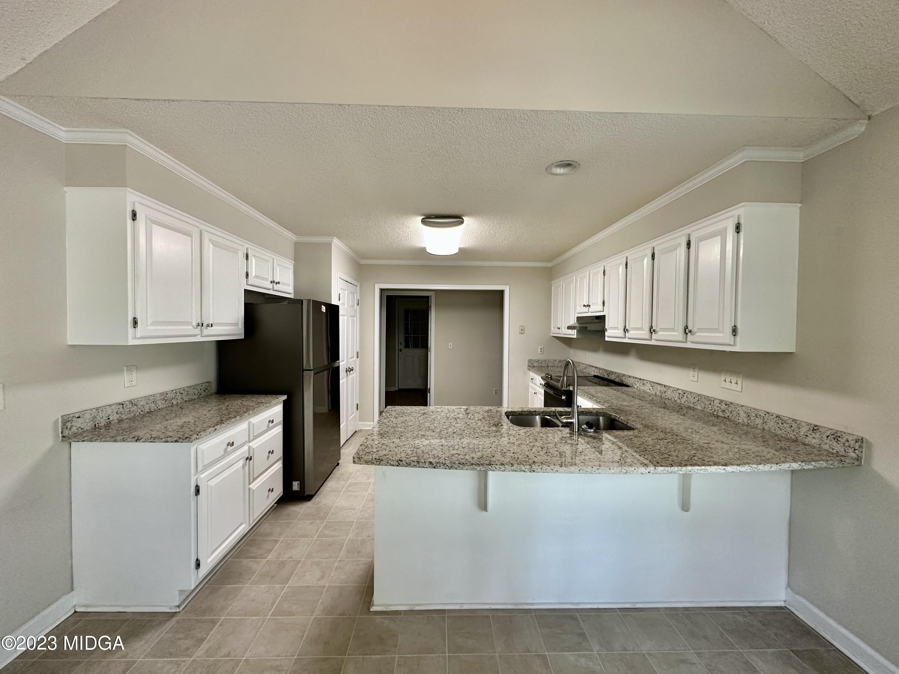 310 Old Oak Road Macon, GA 31216 - Photo 7 of 27 a kitchen with stainless steel appliances granite countertop a sink stove and cabinets