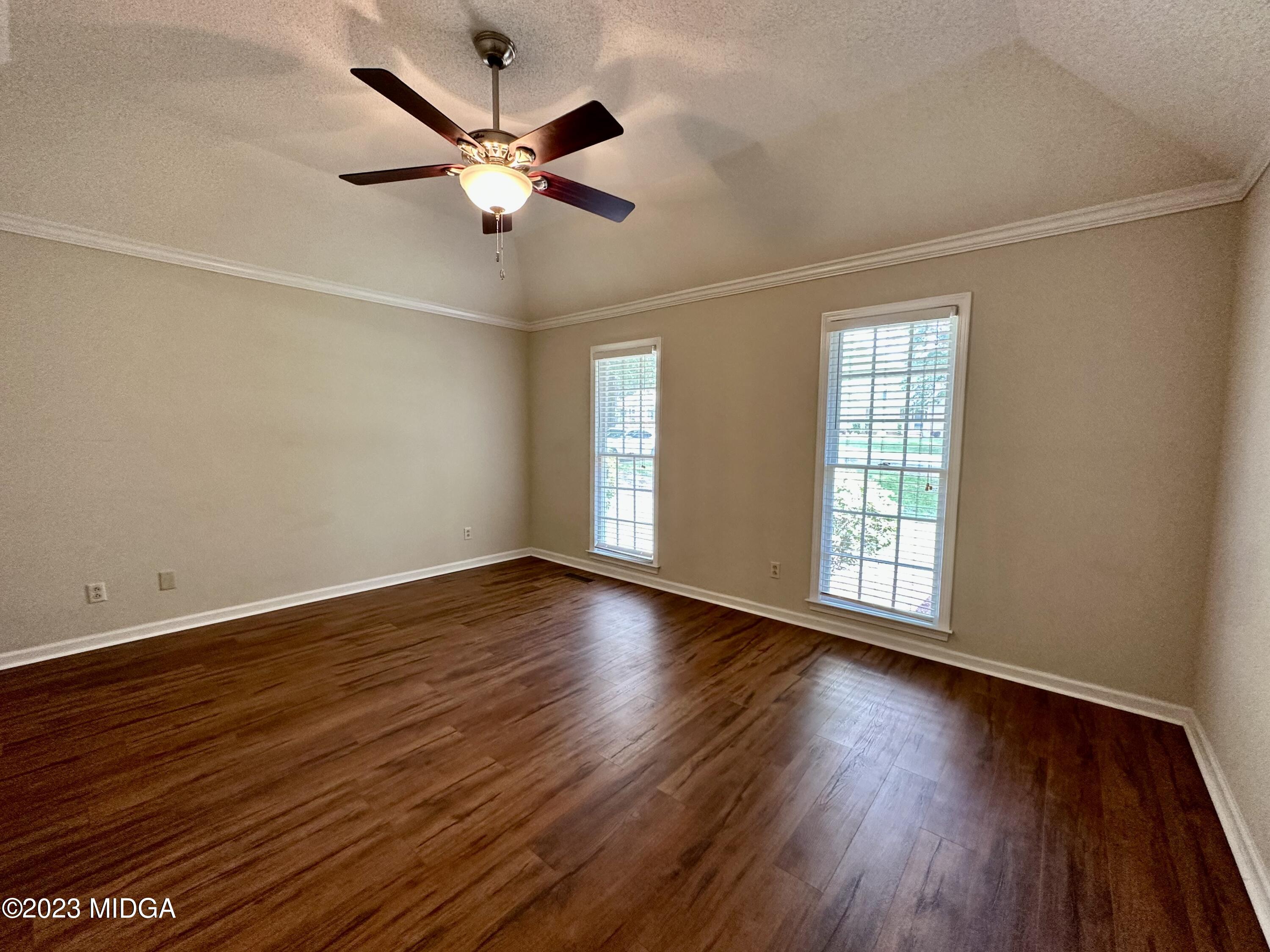 310 Old Oak Road Macon, GA 31216 - Photo 10 of 27 a view of an empty room with wooden floor and a window