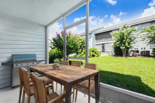 a view of a patio with table and chairs and potted plants