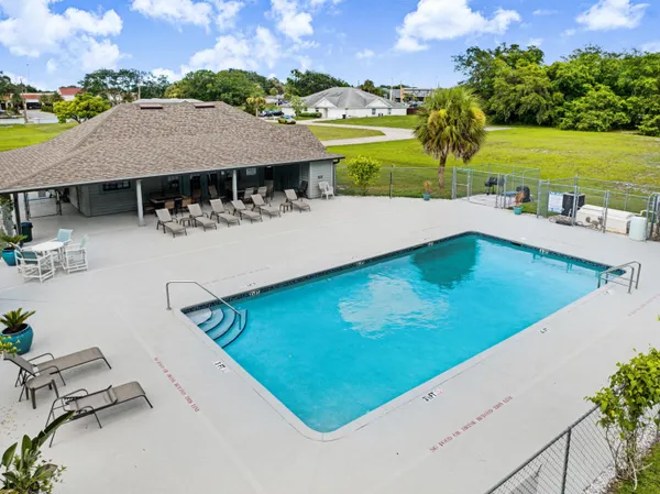 an aerial view of a house with a yard and lake view