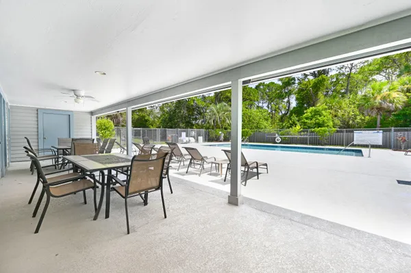 a view of a patio with table and chairs