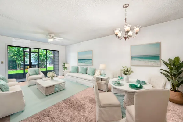 a living room with furniture a chandelier and a chandelier
