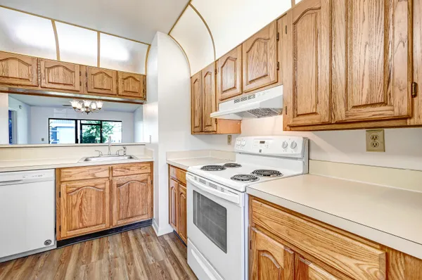 a kitchen with stainless steel appliances granite countertop a stove and a sink